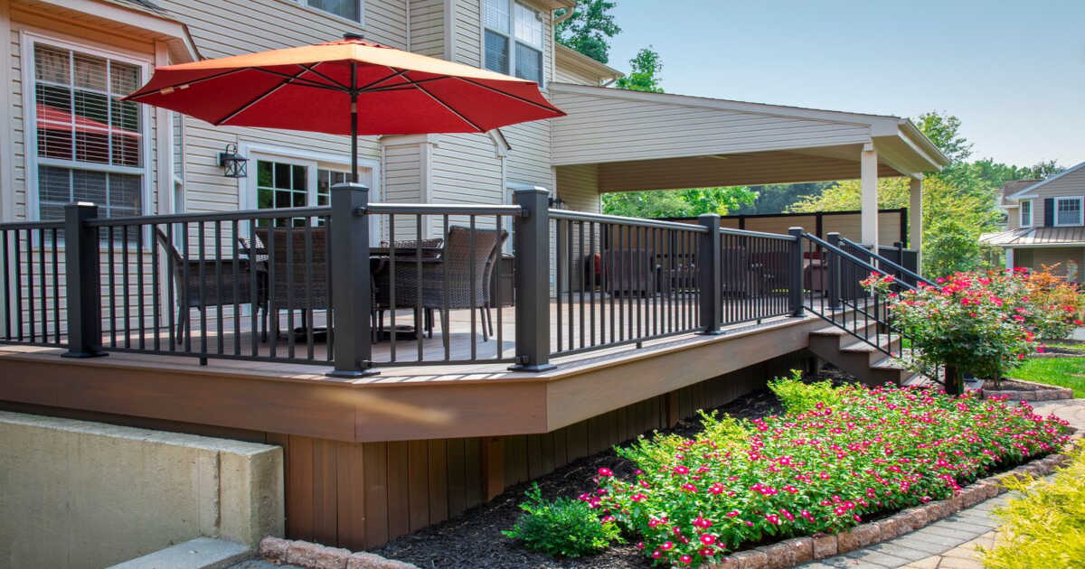 Dark railing on porch with umbrella